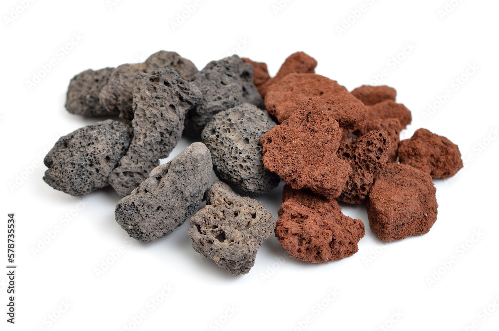 Porous black and brown volcanic rock. Lava stone, pumice stone, or volcanic pumice with distinctive pores Porous black and brown volcanic rock. Lava stone, pumice stone, or volcanic pumice with distinctive pores