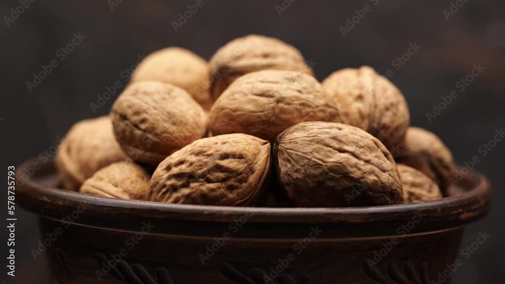 Walnut close up on a wooden table. Walnut close up. product rich in minerals and vitamins. Walnut turns in a shot. Walnut close up on a wooden table. Walnut close up. product rich in minerals and vitamins. Walnut turns in a shot.
