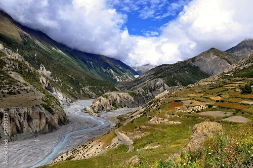 View of the Marshyangdi (Marsyangdi) River valley. Rocky valley of the Marshyangdi river with blue sky in the background. Manang District, Nepal, Asia.
