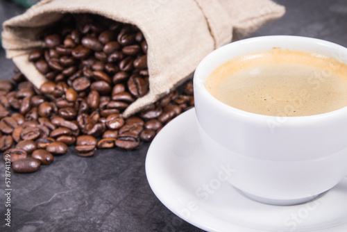 Coffee in cup and roasted dark coffee beans in bag