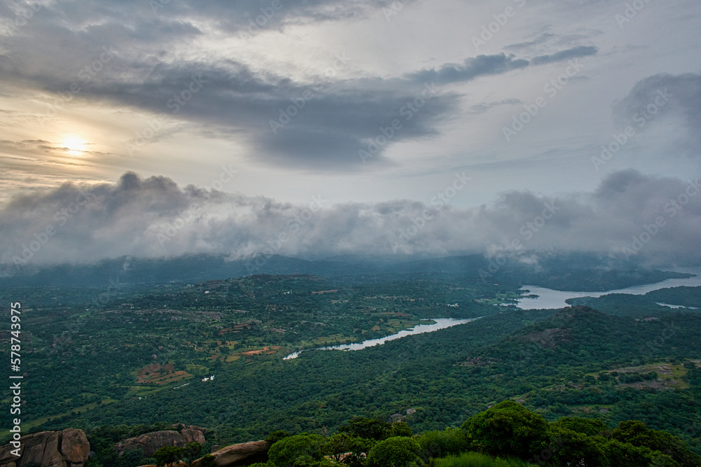 Fototapeta premium Landscape view of a mountain with clouds and river in the morning