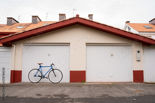 Blue bike in front of garage