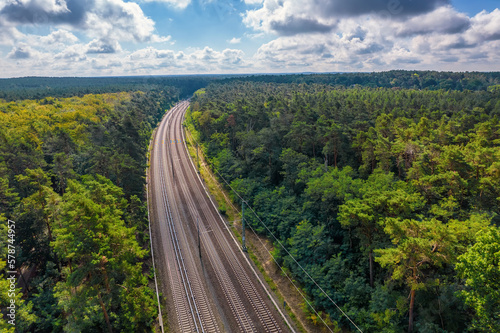 Railway through summer forest, aerial view.