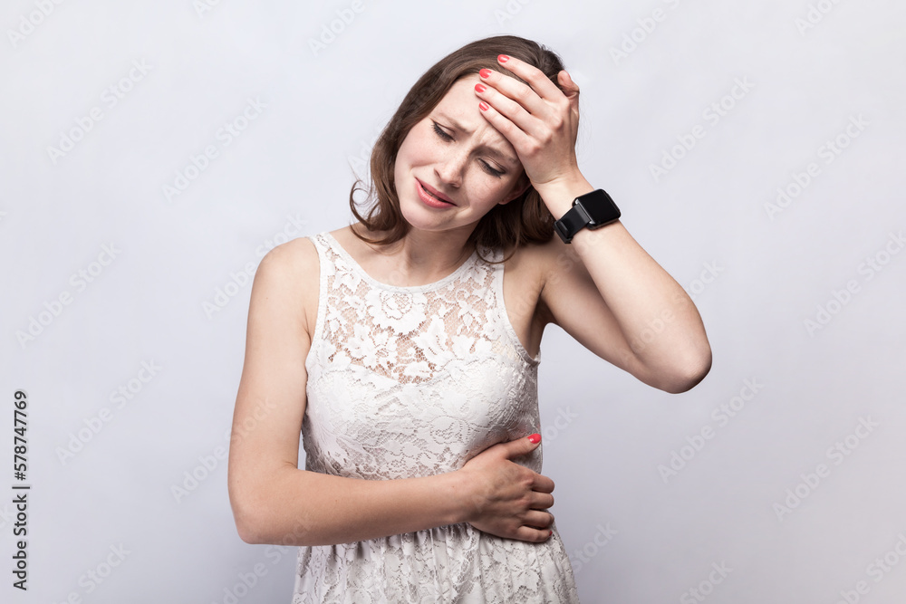 Sick unhealthy woman feels unwell, suffering headache, touching her forehead having high temperature Sick unhealthy woman feels unwell, suffering headache, touching her forehead having high temperature