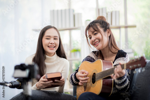 Asian young lover lesbian couple playing guitar and Kalimba with relax and happy moment in living room - LGBT relationship in daily lifestyle concept