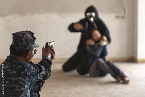 Photos Police cop constable aiming handgun too attack terrorist thief robber with hostage in abandon building