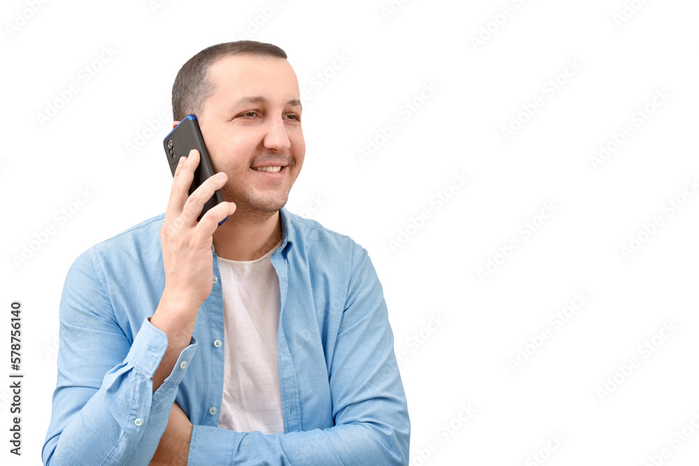 Young man in a denim shirt talking on a mobile phone on a white background. Young man in a denim shirt talking on a mobile phone on a white background.
