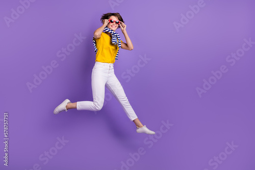 Full length photo of funky crazy positive lady wear trendy clothes moving empty space seasonal sale isolated on purple color background
