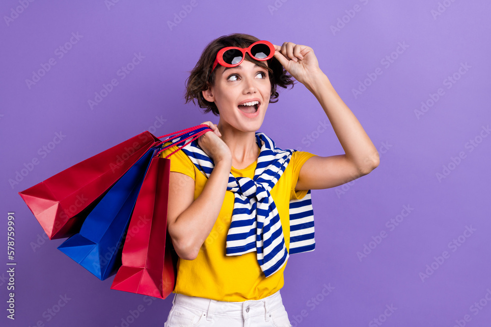 Photo of positive lady wear trendy clothes tied pullover shoulder look up empty space offer low price isolated on purple color background