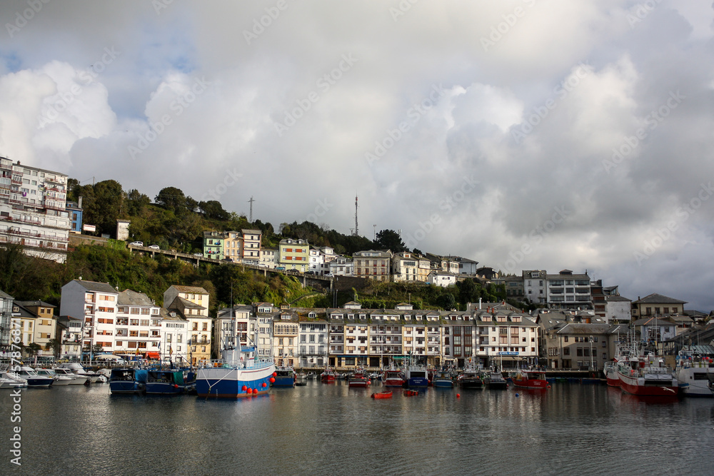 Small fishing port of Luarca, Spain, with the characteristic residential buildings in the background