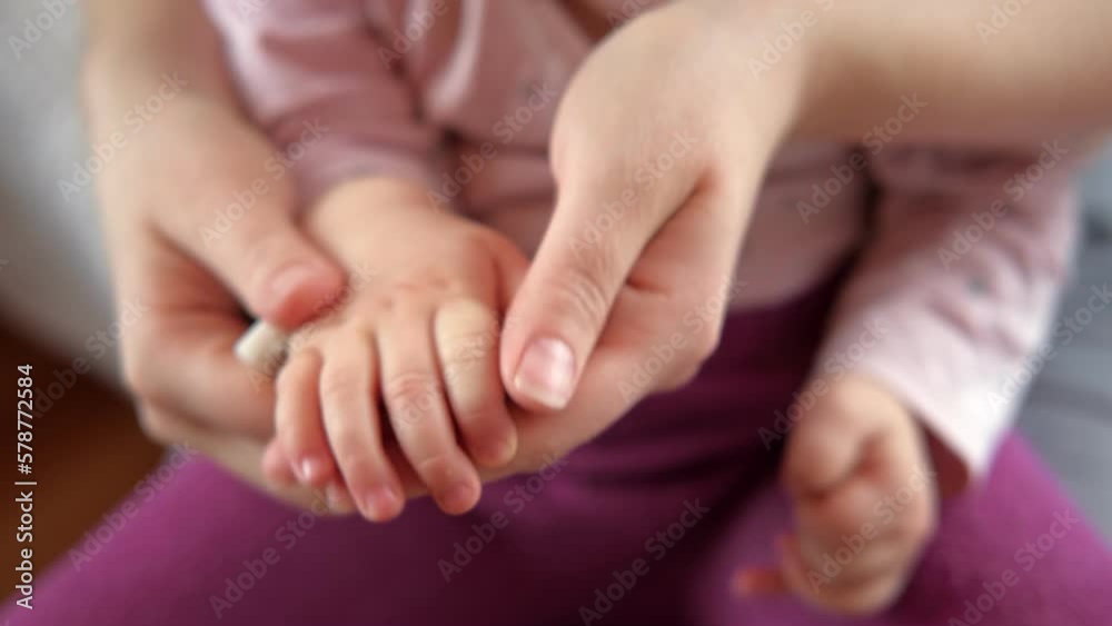 Mother use Nail Trimmer with baby hand. Mom cutting tiny fingernails. Baby care concept. How to successfully clip your baby's nails. Closeup. Newborn hygiene. Clipping Child's Nails. Front view. Mother use Nail Trimmer with baby hand. Mom cutting tiny fingernails. Baby care concept. How to successfully clip your baby's nails. Closeup. Newborn hygiene. Clipping Child's Nails. Front view.