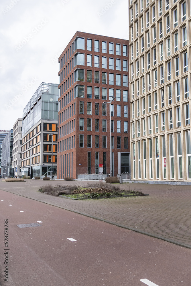 View of high-density residential and business area on the banks of the IJ River at the Oostelijke Handelskade (Eastern Docklands). Amsterdam, The Netherlands. 