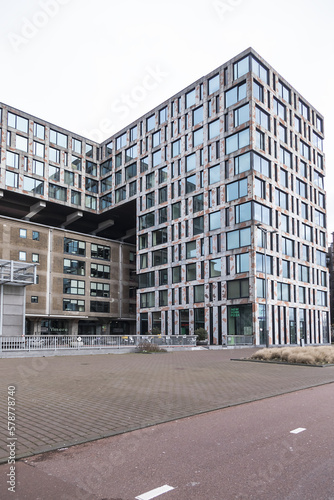 View of high-density residential and business area on the banks of the IJ River at the Oostelijke Handelskade (Eastern Docklands). Amsterdam, The Netherlands. 