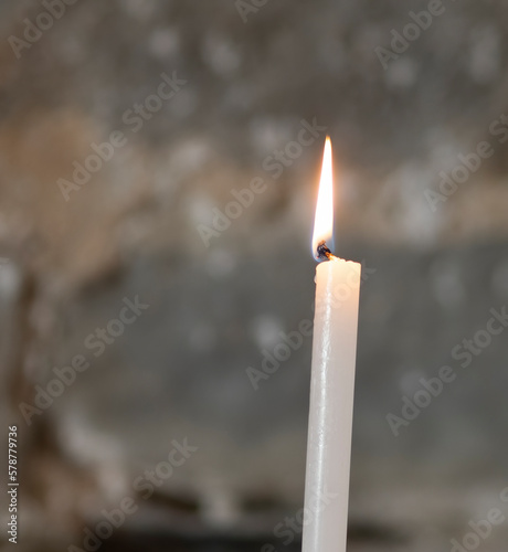 Candles in a Christian church background. Flame of candles in the dark sacred interior of the temple