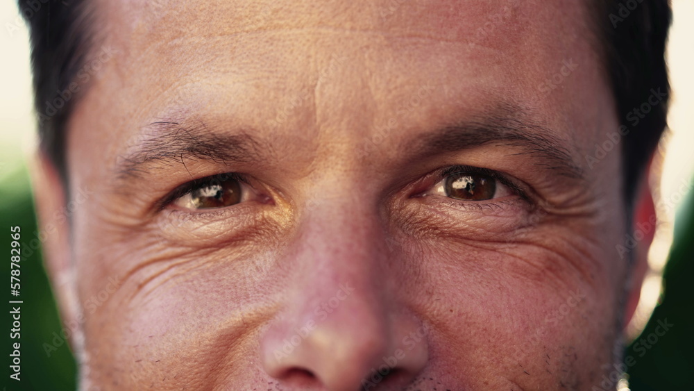 Macro close up of a man in 40s looking at camera smiling with wrinkles