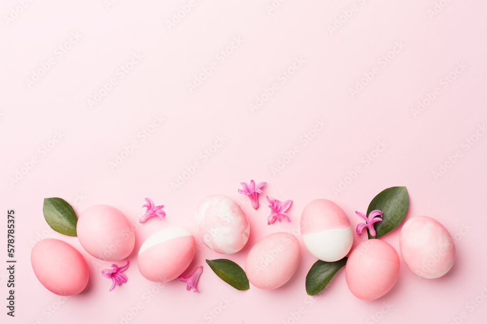 Pink Easter eggs on color background, top view