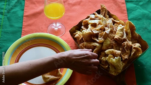Footage with a table laden with lies or chiacchiere, a typical sweet of the carnival in Italy. Concept of traditional and local food, party , enjoy party time. photo