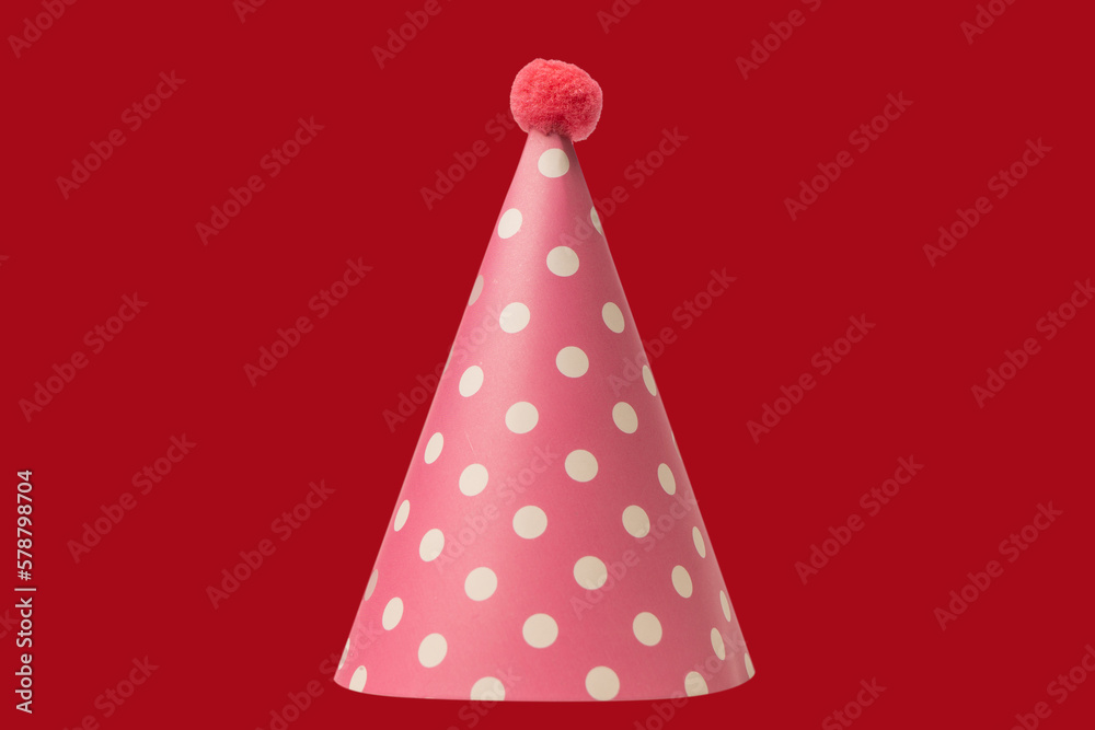 Bright and colorful birthday cap isolated on a red background. Bright and colorful birthday cap isolated on a red background.