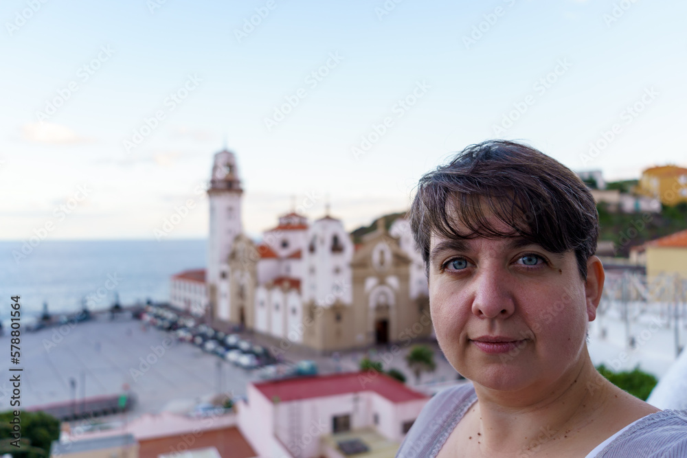 Portrait of a young female tourist against a clear sky in Spain