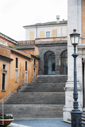 Stairs in Rome with ochre walls on the building  Steps near piazza Campidoglio