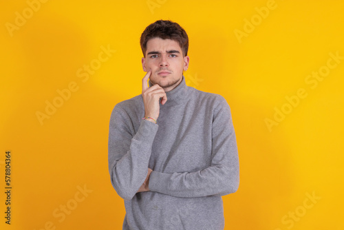 young man isolated on yellow background