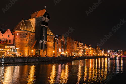 Night panoramic view at embankment and Zuraw crane in the historical center of Gdansk, Poland