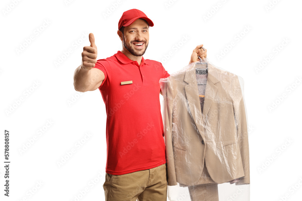 Worker holding a suit on a hanger with a plastic cover and gesturing thumbs up Worker holding a suit on a hanger with a plastic cover and gesturing thumbs up