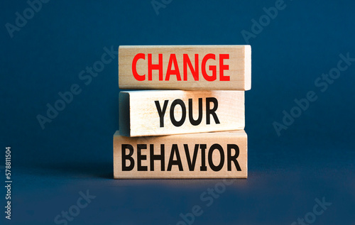 Motivation and Change your behavior symbol. Concept words Change your behavior on wooden block on a beautiful grey table grey background. Business change your behavior concept. Copy space.