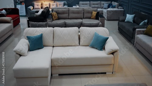 White sofa with two blue decorative pillows. Concept for a comfortable living room. 4k slow motion video.