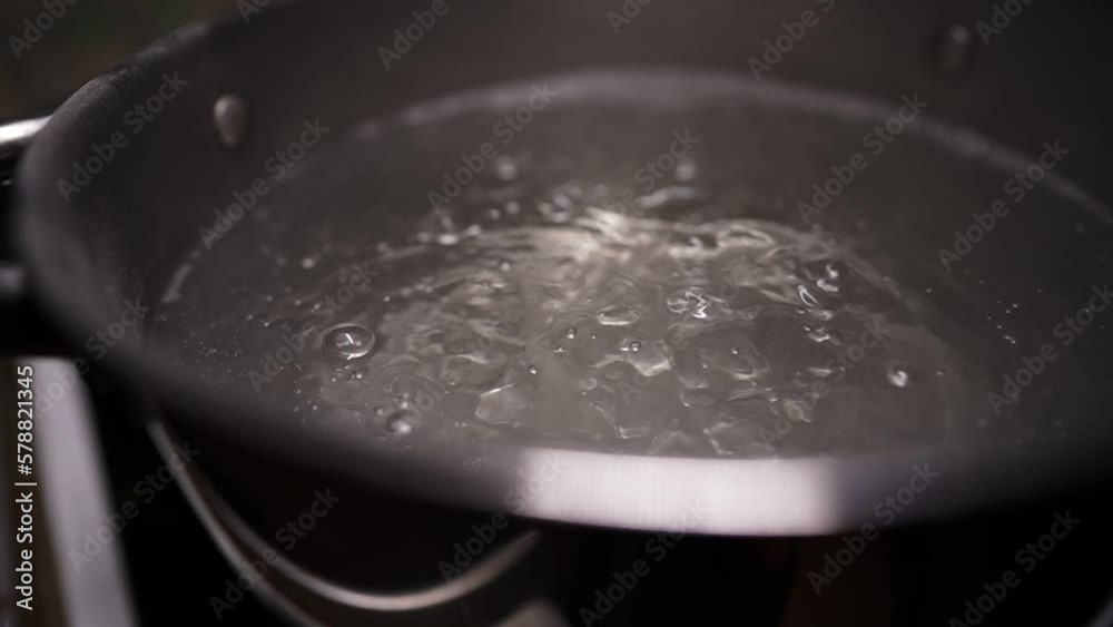 Water is boiling in a pot on the stove. Boiling water in slow motion. Water is boiling in a pot on the stove. Boiling water in slow motion.