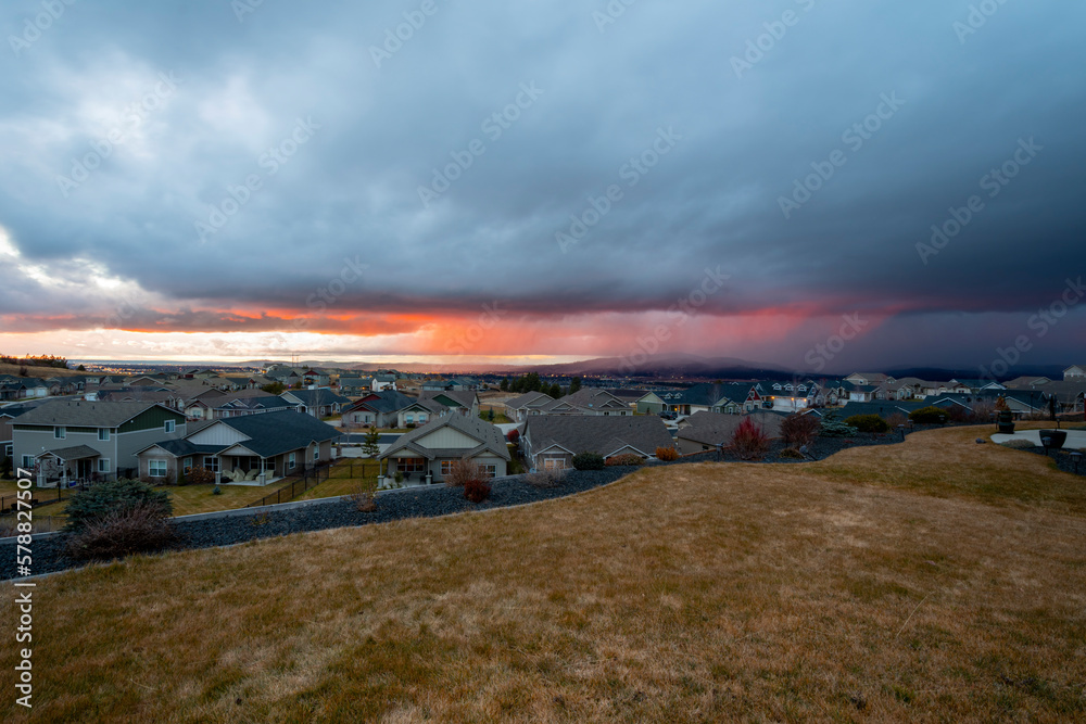 Panoramic view of the Spokane Valley and downtown Spokane during a colorful rainstorm at sunset taken from a hill in Liberty Lake, Washington, USA	