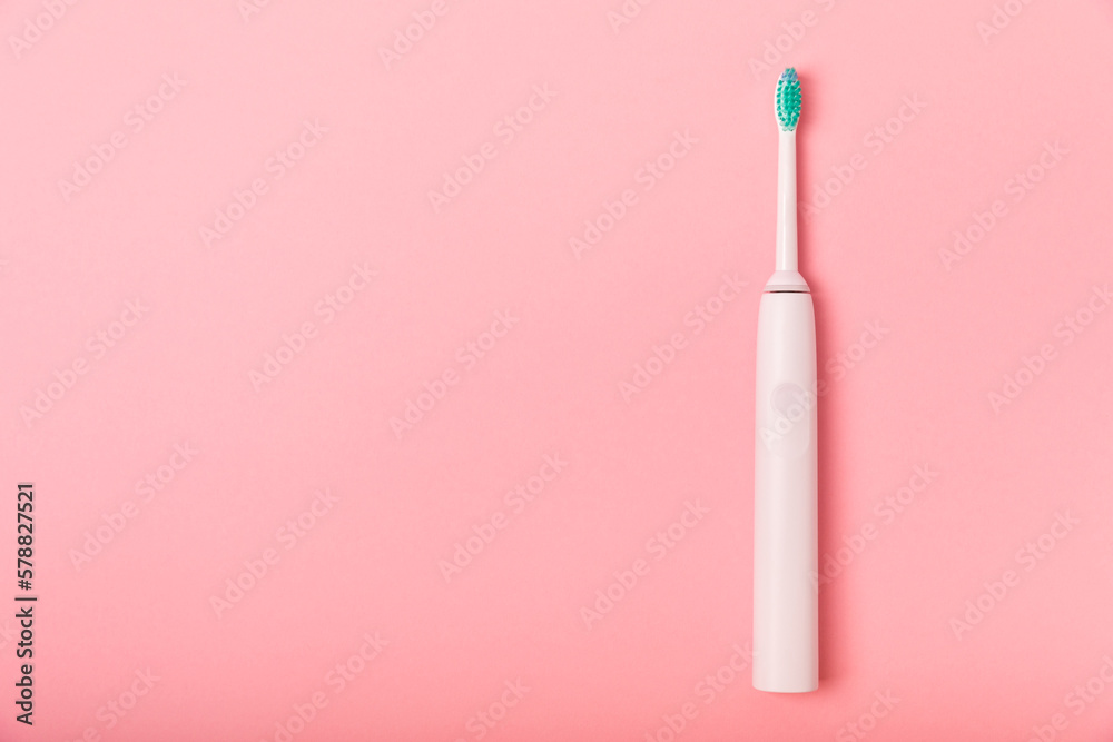 Electronic ultrasonic toothbrush on a pink background.Smart electric toothbrush. Items for dental care and caries prevention. Dentistry concept. Modern technologies for health. Healthy teeth. Electronic ultrasonic toothbrush on a pink background.Smart electric toothbrush. Items for dental care and caries prevention. Dentistry concept. Modern technologies for health. Healthy teeth.