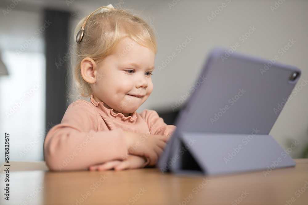 Deaf child girl with cochlear implant studying to hear sounds - recovery after cochlear Implant surgery and rehabilitation concept Deaf child girl with cochlear implant studying to hear sounds - recovery after cochlear Implant surgery and rehabilitation concept