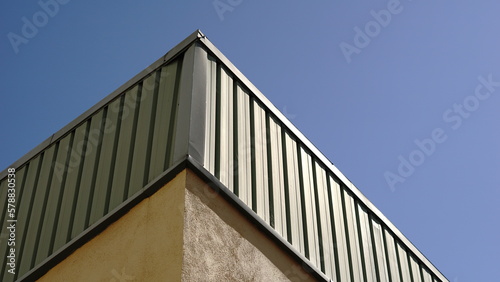 warehouse corner roof against the sky