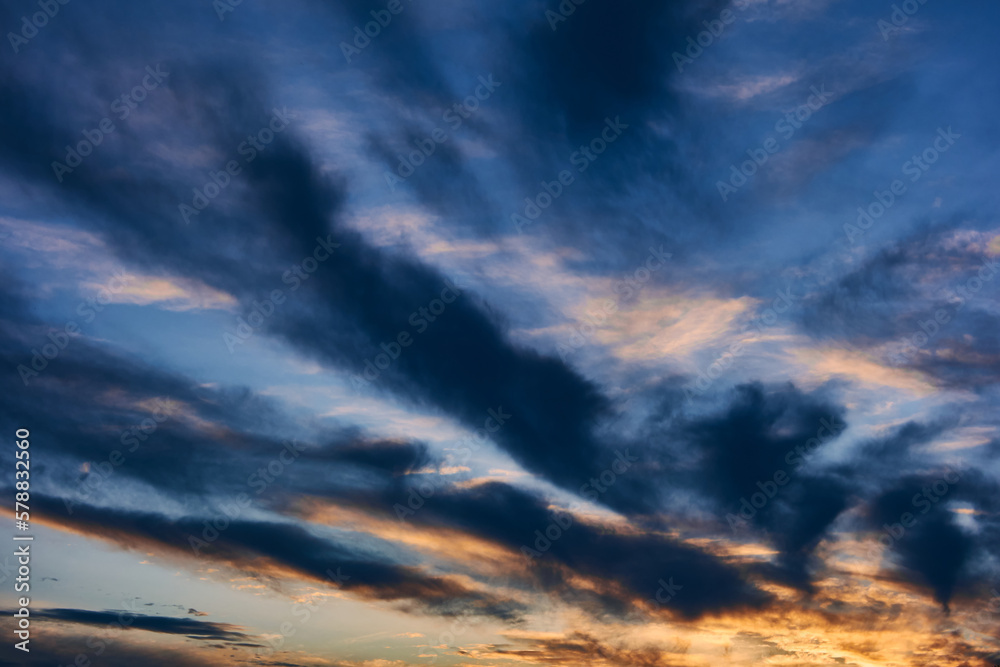 Obraz premium Landscape of the summer sky at sunset, clouds of different colors and bizarre shapes create a beautiful picture, natural texture