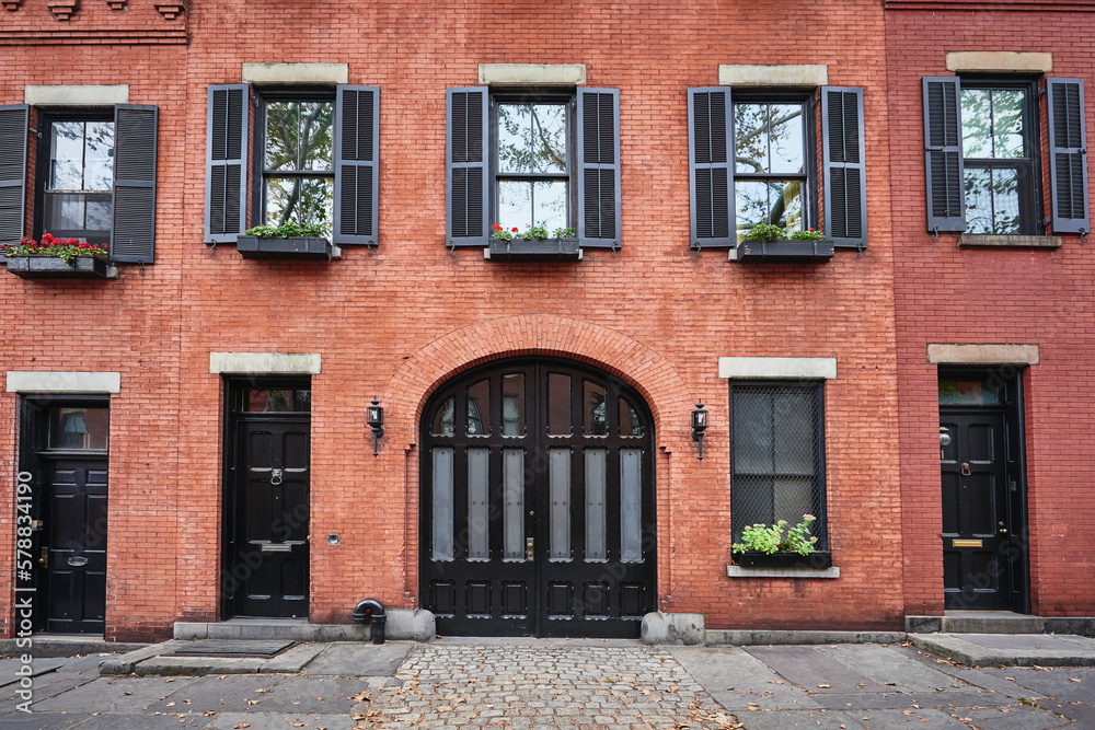 a beautiful brownstone building on an iconic street of Manhattan, NYC. a beautiful brownstone building on an iconic street of Manhattan, NYC.