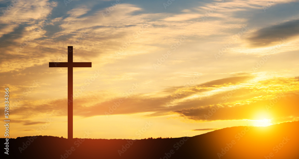 Christian cross on hill outdoors at sunrise. Resurrection of Jesus. Concept photo.