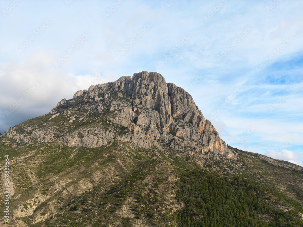 Landmark Puigcampana peak in the heart of the Costa Blanca, Spain.
Imposing mountain Puig Campana with a blue cloudy sky. Landscape located in Finestrat, located in the Valencian Community, Alicante