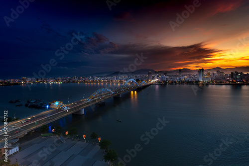 Night scenery of Da Nang city, Vietnam with the magic of light from the bridges, buildings, and daydreaming of the river flowing to the sea