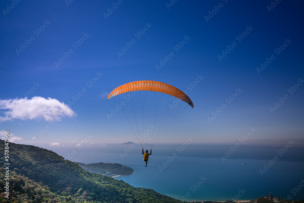 Da Nang city, Quang Nam province, Vietnam - June 25, 2017: flying paragliding on top of Son Tra Mountain. This is a regular activity of parachute flying club Da Nang city, Quang Nam province, Vietnam - June 25, 2017: flying paragliding on top of Son Tra Mountain. This is a regular activity of parachute flying club