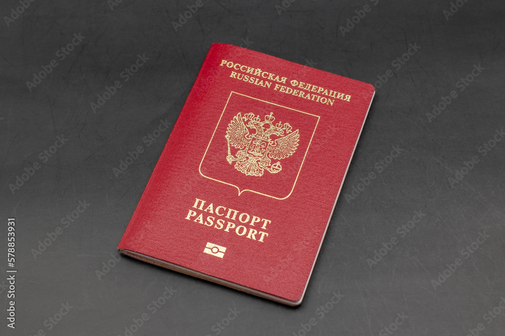 Russian travel passport on a black background, sanctions, emigration, immigration, tourism concept Russian travel passport on a black background, sanctions, emigration, immigration, tourism concept