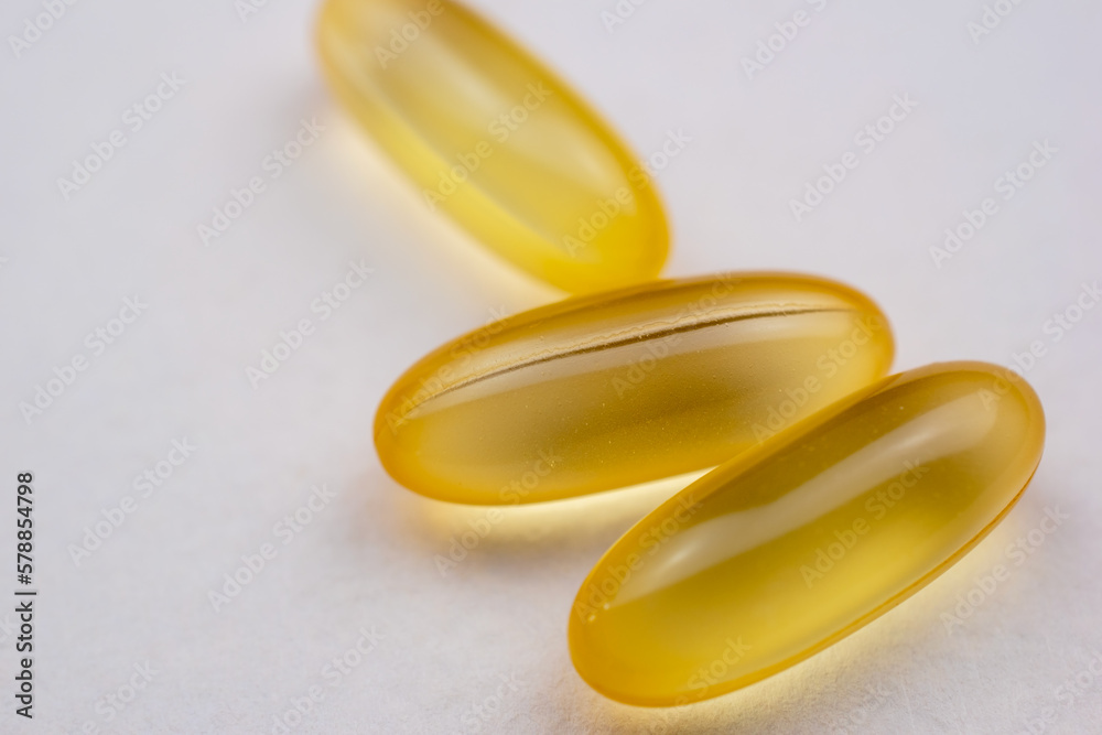Yellow pills, bioactive fish oil supplement, colorful tablets, medicines, drugs, health care concept Yellow pills, bioactive fish oil supplement, colorful tablets, medicines, drugs, health care concept
