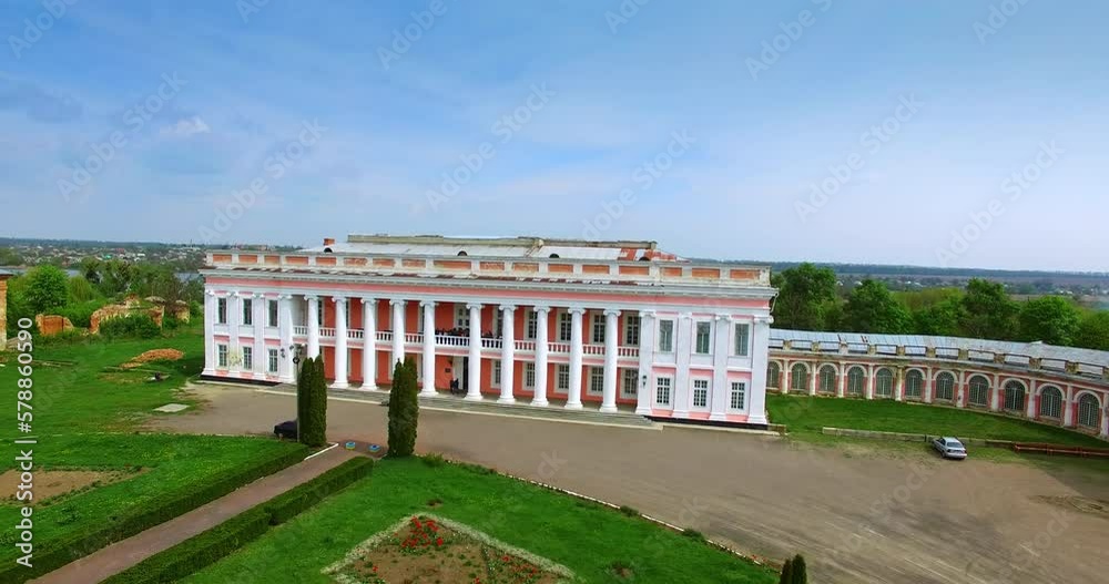 Distancing from a gorgeous two-storied palace with people on balcony. Neat territory in front of the building. Tulchin city, Ukraine. Distancing from a gorgeous two-storied palace with people on balcony. Neat territory in front of the building. Tulchin city, Ukraine.