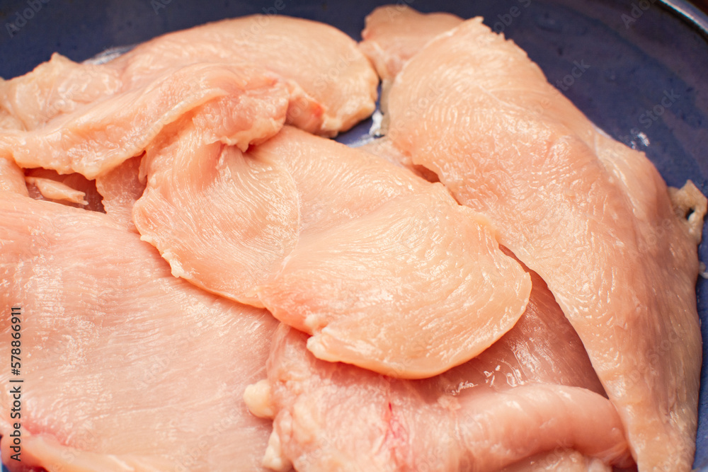 Raw chicken meat breast, seasoned, close up view Raw chicken meat breast, seasoned, close up view