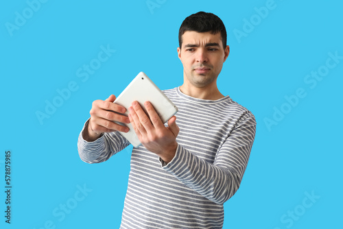 Confused young man holding ...