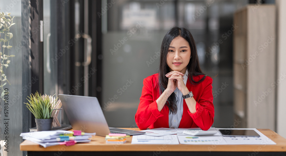 Asian businesswoman analyzing reports while working in workplace office. Asian businesswoman analyzing reports while working in workplace office.