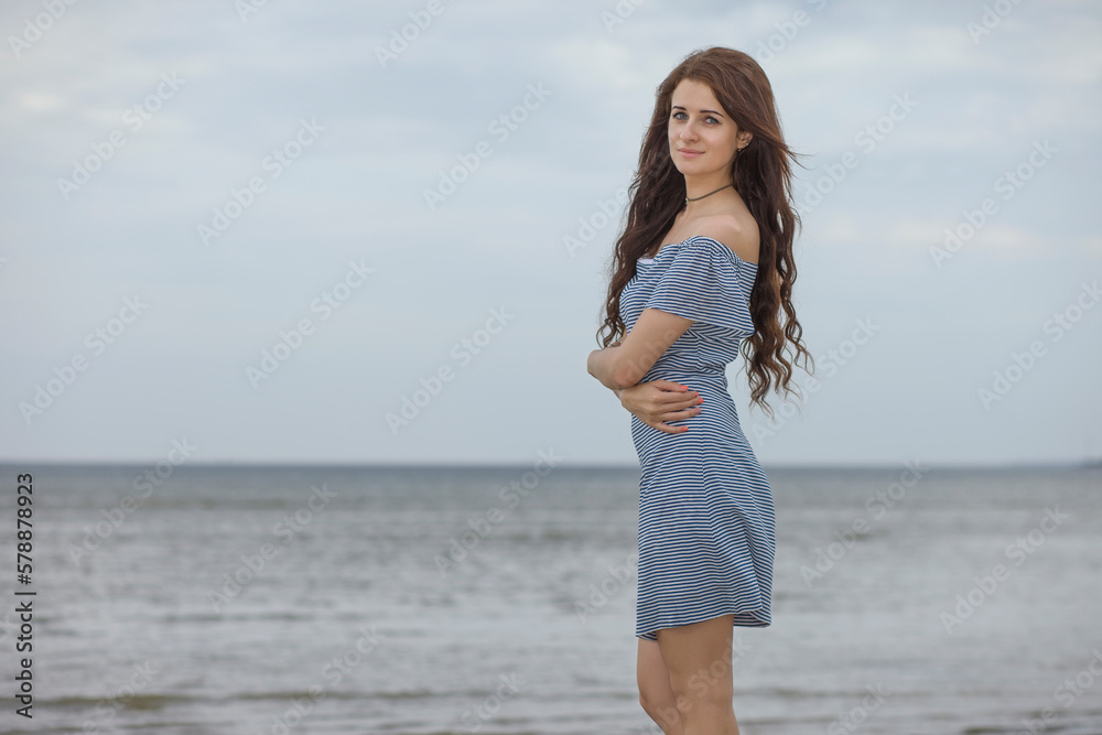 young slender woman by the sea