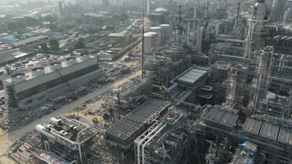 4k, hyper lapse circle drone shot, industrial plant construction project, crude oil and gas refinery new construction site large scale, aerial view,