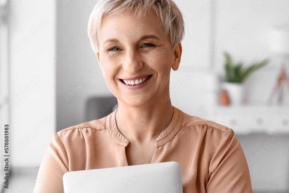 Mature woman with laptop at home, closeup Mature woman with laptop at home, closeup