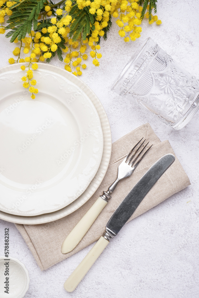 Table setting with beautiful mimosa flowers on grey grunge background - obrazy, fototapety, plakaty 